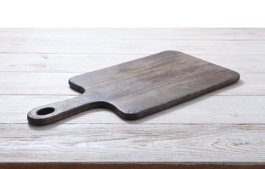 Cutting board on the wooden background. Top view.