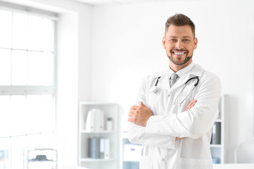 Naklejka na ściany i meble Male doctor with stethoscope in clinic