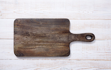 Cutting board on the wooden background. Top view.