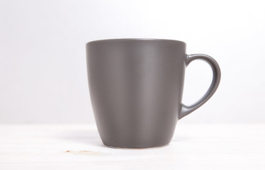 Mug Mockup. Gray Mug on wooden table.