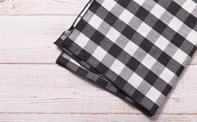 Napkin. Kitchen towel or table cloth on white wooden scene. Mock up for design. Top view.