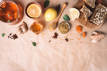 Autumn harvest concept. Set of honey and bee products, apple, lemon, calendula tea, spices on craft paper background. Immune system support with alternative medicine