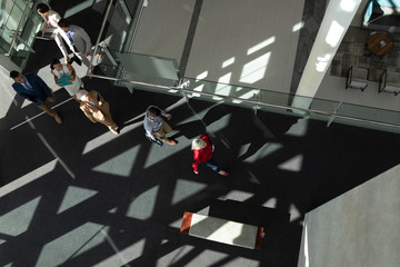 High angle view of business people arriving at office lobby
