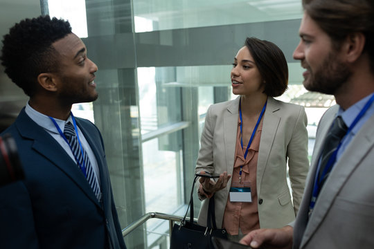 Multi-ethnic business colleague interacting with each other in the elevator
