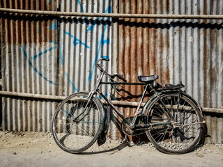 Fototapeta na wymiar Bicycle Propped Against Fence