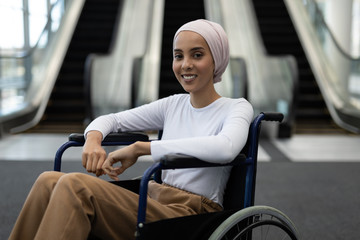 Beautiful disabled female executive in the lobby at office