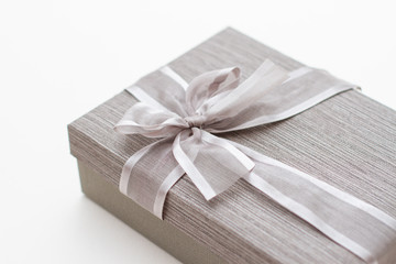 silver gift box with bow on a white background. close-up