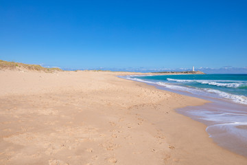 beautiful and idyllic landscape of wild natural beaches of Zahora and Cala Isabel, near Canos Meca village (Barbate, Cadiz, Andalusia, Spain) and Cape Trafalgar with lighthouse