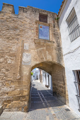 Fototapeta na wymiar ancient Segur Gate, from XV century, in public street of typical Andalusian village named Vejer de la Frontera (Cadiz, Andalusia, Spain, Europe)