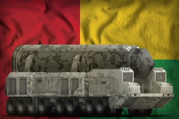 intercontinental ballistic missile with city camouflage on the Guinea-Bissau national flag background. 3d Illustration