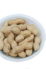 Peanuts in nutshell in a bowl isolated on white background