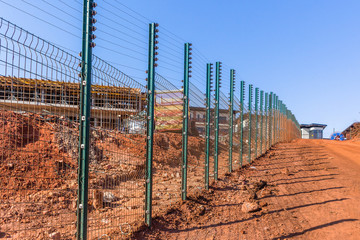 New Security Fence Electrified Dirt Road Construction Building Apartments Blue Sky Rural Countryside