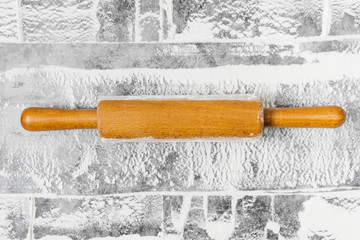 Baking flat lay with rolling pin, flour on gray background. Bake menu, recipe, homemade pastry concept. Top view, with copy space for your text.