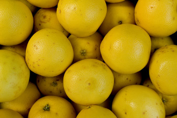 group of yellow grapefruits, fresh, natural, at local fruit market, agriculture, food, diet, vitamins, nourishment, juice, summer, background, Milan, Italy
