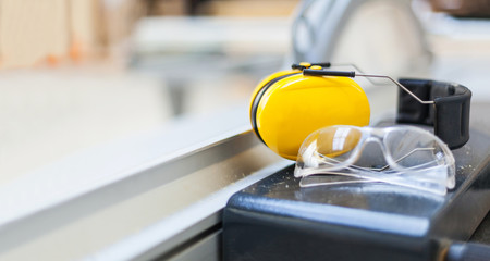 Arbeitsschutz Schutzbrille und Gehörschutz auf Kreissäge in Werkstatt Hörschutz, Lautstärke,...