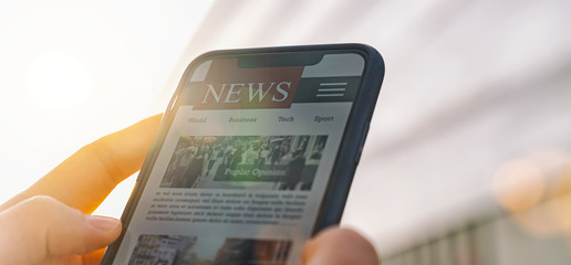 Online news article on smartphone screen. Electronic newspaper or magazine. Latest daily press and media. Mockup of digital portal and website. person using web service in the morning. Reading text.