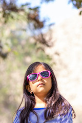 Portrait of girl with sunglasses and blue striped shirt