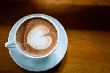 Hot Coffee Late Art on Wood Table in Coffee Shop