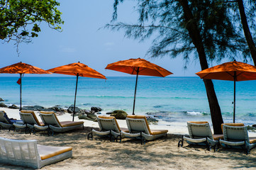 chairs and umbrella on tropical beach