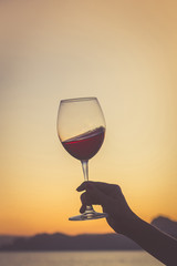 Fototapeta na wymiar Glass of wine at sunset