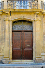 Fototapeta na wymiar facade of mediterranean building with wooden door 