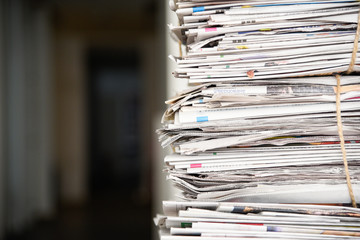Pile of newspaper, background texture. Lots of retro journals with headlines, articles and photos