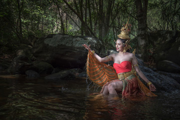 Beautiful woman in a Kinnari dress, Kinnara is an animal in the Himmapan forest.The upper body is human.The lower part is a bird with wings to fly.Lives in the Himapan forest.