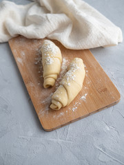 Two blanks for croissants, beautiful pretzels on a wooden Board, beautiful runner, linen towel, on...