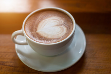 Hot Coffee Late Art on Wood Table in Coffee Shop