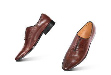 Empty brown boots in a jump on an isolated white background
