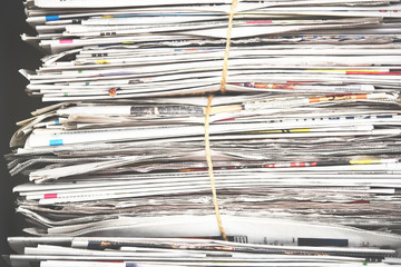 Pile of newspaper, background texture. Lots of retro journals with headlines, articles and photos