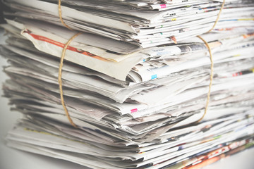 Pile of newspaper, background texture. Lots of retro journals with headlines, articles and photos
