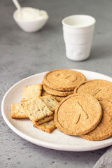 Fototapeta na wymiar Thin crispy wholegrain crackers with natural yogurt and milk. Simple breakfast or snack. 