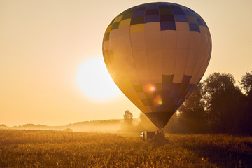 A balloon soared into the sky in fog at dawn.