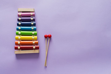 A toy wooden colorful xylophone on purple background with copy space. Children's toy and musical...