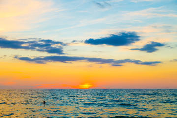 Naklejka na ściany i meble Silhouette sunset sea beach colorful sky