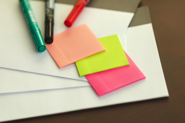 From above vibrant stickers and highlighters over blank paper arranged on table