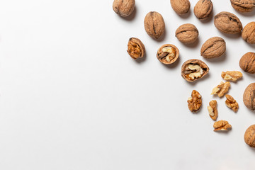 Group of walnuts and peeled walnuts on the white background
