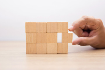 Hand Choosing wooden block,wood cubes Arrange stacking with out graphic for Business concept growth and success process.