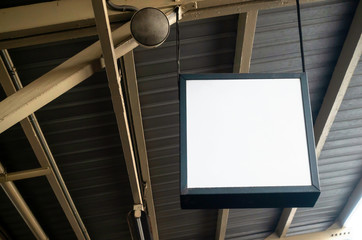 hanging blank advertising billboard or light box showcase on wall at airport or subway train station, copy space for your text message or media content, advertisement, commercial and marketing concept