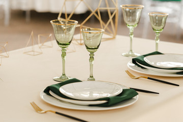 Served for wedding restaurant table with dishes, glasses,  cutlery