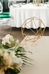 Fototapeta na wymiar Wedding gold geometric decoration on the table