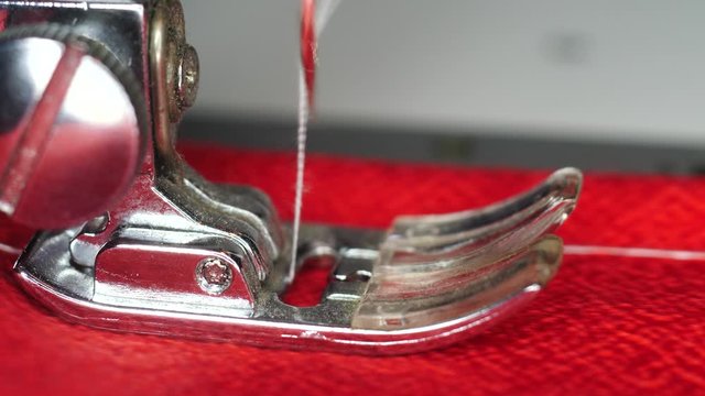 Sewing machine makes a seam macro shot