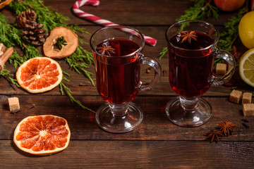 Christmas hot mulled wine with cinnamon cardamom and anise on wooden background