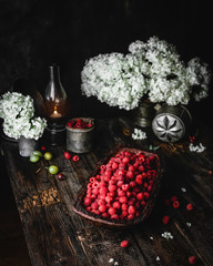 ripe raspberries in wooden bowl on brown wooden table