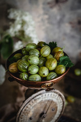 gooseberries in copper bowl on old kitchen scale