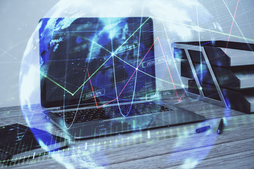 Stock market chart with globe hologram and desktop office computer background. Multi exposure. Concept of financial analysis.