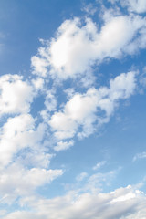 White fluffy clouds in the blue sky in summer