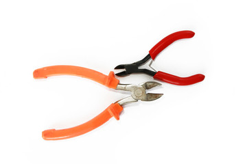 two metal old rusty pliers with red and orange handle