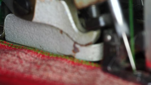 Retro overlock sew machine is working macro panoramic shot